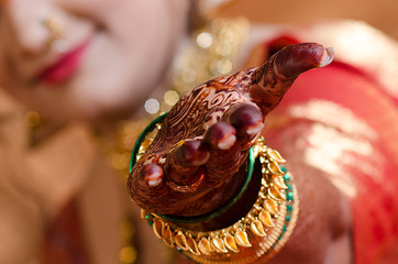 bride with beautiful henna on hand
