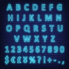 Blue neon English alphabet, digits and signs on brick wall. Characters set. Night bright neon sign, colorful billboard, light banner. Vector illustration in neon style. © RedlineVector