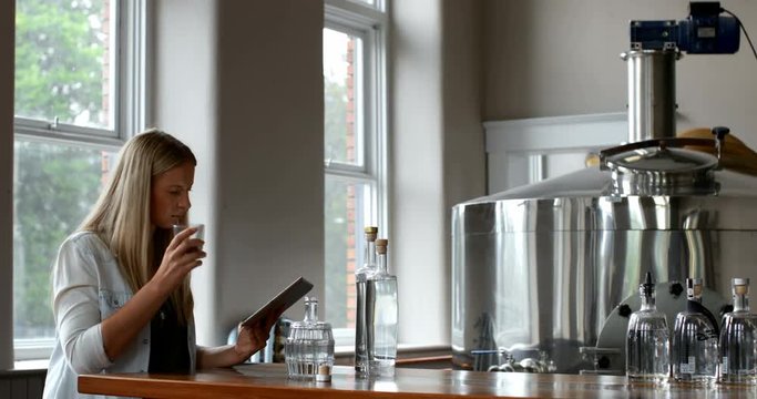 Female worker using digital tablet in distillery factory 4k