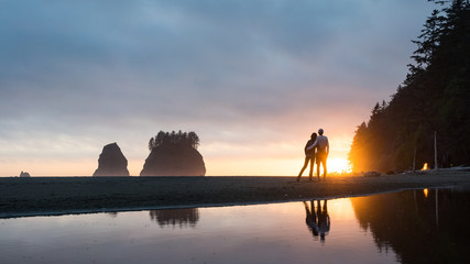 Couple enjoying summer sunset at iconic La Push beach in Olympic National Park