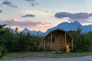 Girl enjoying sunset at the cabin in Glacier National Park