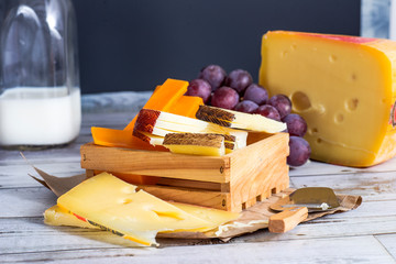 cheese with grapes on  wooden table