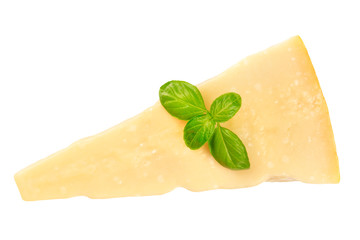A piece of aged Parmesan cheese with fresh basil leaves, shot from the top, isolated on a white background with a clipping path