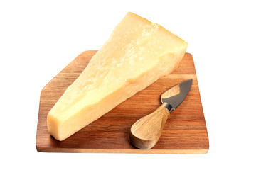 A piece of aged Parmesan cheese on a wooden cutting board with a cheese knife, isolated on a white background with a clipping path