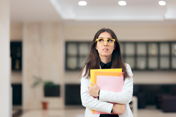 Confused Businesswoman Holding Paperwork in Office Building