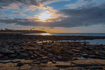 Sunset over rocky coastline