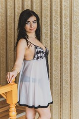 Fototapeta premium Cozy home concept. Sexy Lady in erotic lingerie, Pastel snd wood interior. Woman with romantic mood. Morning time 