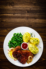 Grilled pork chop, boiled potatoes and green beans