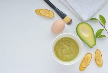 Natural home made face mask with avocado, banana and egg, top view with copy space.