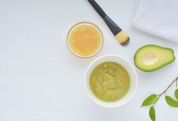 Homemade face mask with avocado and honey, natural skin moisturizer, flat lay, space for text.