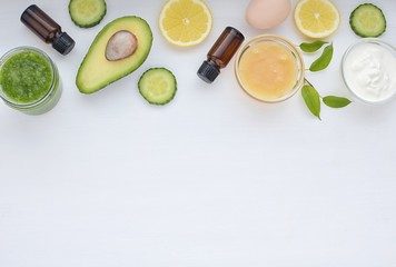 Natural ingredients for homemade cosmetics, avocado, honey, cucumber, eggs, yogurt, lemon. Skin treatment flat lay with space for text.