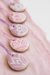 Homemade gingerbread Easter lilac and pink color in the form of egg with a floral pattern.