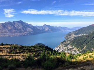 Naklejka na ściany i meble A spectacular view of the lookout over the gorgeous town of Queenstown and Lake Wakatipu, New Zealand