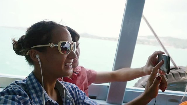 Happy couple in sunglasses taking selfie using phone smiling while floating on vacation. slow motion. 1920x1080