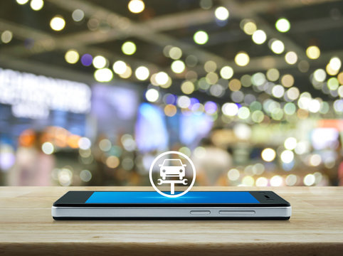 Service fix car with wrench tool flat icon on modern smart mobile phone screen on wooden table over blur light and shadow of shopping mall, Business repair car online concept