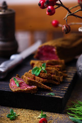 Caucasian basturma with spices on a chopping board