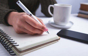 notebook pen coffee writing