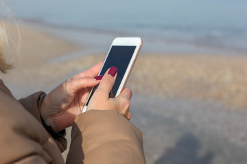 Beautiful Woman Using Smart Phone On A Beach