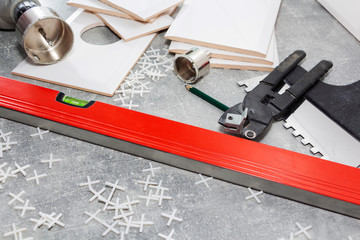 Ceramic tiles and tools for tiler, tiles installation. Home improvement, renovation - ceramic tile floor adhesive, mortar, level