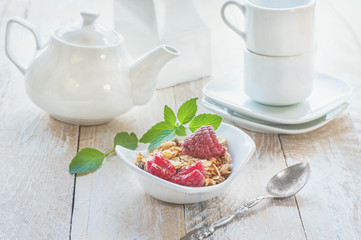 Healthy breakfast with muesli, milk and fresh berries on light napkins, selective focus