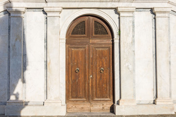 Double arched wooden doors with metal ring handles