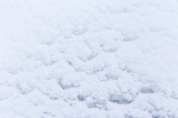 Close-up of fresh built up snow, good as a winter season background or texture. A slight blue hue.