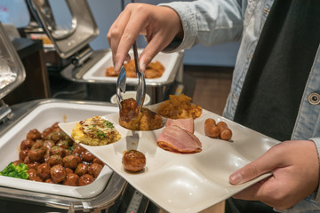 Tourists taking food in the buffet hotel restaurant