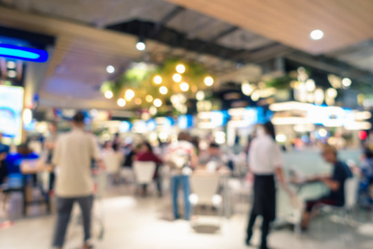 Abstract blurred defocusing of food court in the mall., Motion blurry image inside of department store., Business customer service.