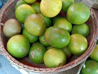 Fresh green lime in basket for sale.