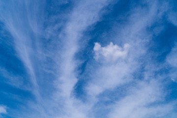 A picturesque formation of fluffy white clouds in the sweet clear blue sky background has created a scenic atmosphere on a sunshine day.