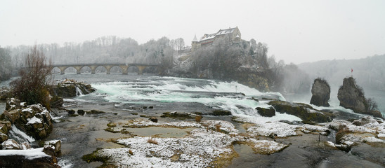 Rhine Falls in Switzerland on a winter day with snow falling