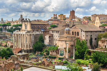 Fototapeta na wymiar Ruins of Roman Forum. Temple of Antoninus and Faustina, Basilica of Santi Cosma e Damiano and others. Rome. Italy