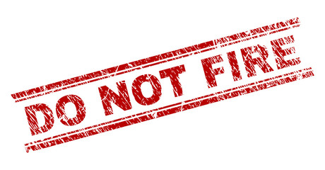 DO NOT FIRE seal print with distress texture. Red vector rubber print of DO NOT FIRE tag with dust texture. Text tag is placed between double parallel lines.