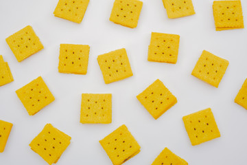 flatlay many square biscuits on white background.