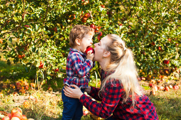 Mother and daughter are bite an apple