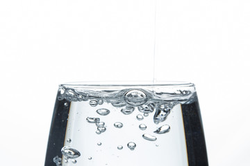 A glass of water on a white background. Close-up