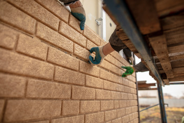 Obraz premium Installation of plastic siding under the brick