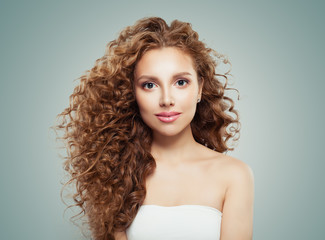 Fototapeta premium Young beautiful model woman with long healthy hairstyle on gray background