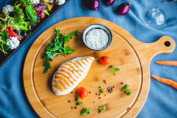 chicken fillet with sauce and salad