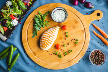 chicken fillet with sauce and salad