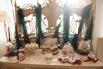 Candy bar. White wedding cake standing of festive table with deserts, tartlet and cupcakes. Wedding.