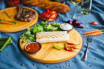 pita kebab on a table with wine and snacks