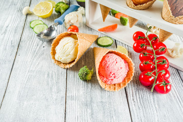 Trendy vegan food, summer healthy dessert concept, colorful diet vegetable ice cream with avocado, cucumber, tomato, beet, carrot, broccoli, cauliflower. Frozen veggie smoothie, wooden background