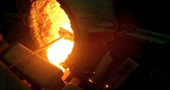 Molten metal being poured in mold at foundry workshop 4k