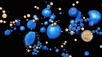 Oil ink of blue, orange and gold colors mix one into another on black background creating beautiful patterns of drops and bubbles. Colorful sparkling paints spread on the surface in amazing design. - Powered by Adobe