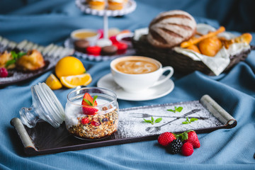 breakfast with coffee, cereal, croissant, yogurt, bread, biscuits