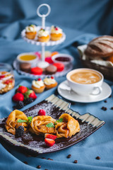 breakfast with coffee, cereal, croissant, yogurt, bread, biscuits