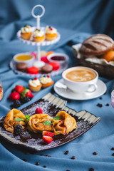 breakfast with coffee, cereal, croissant, yogurt, bread, biscuits