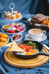 poached egg, breakfast with coffee and scrambled eggs and toast in a pan