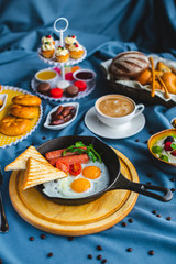 poached egg, breakfast with coffee and scrambled eggs and toast in a pan